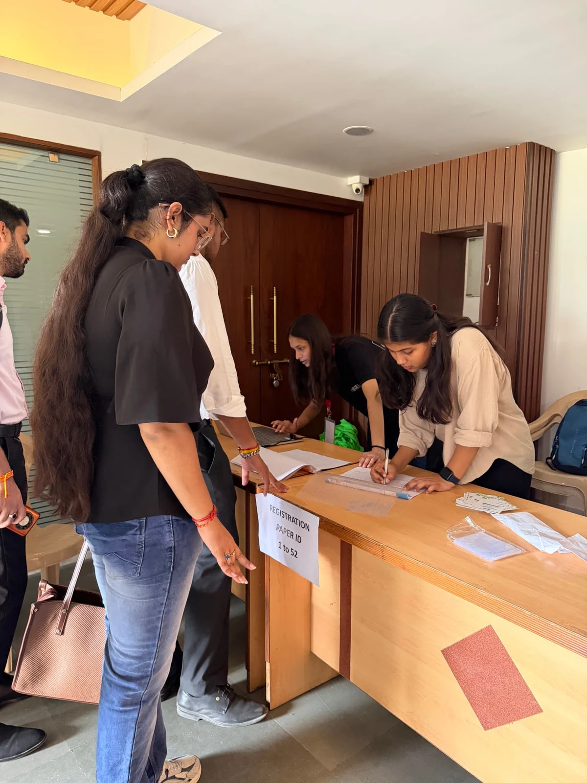Participants checking in at the conference registration desk