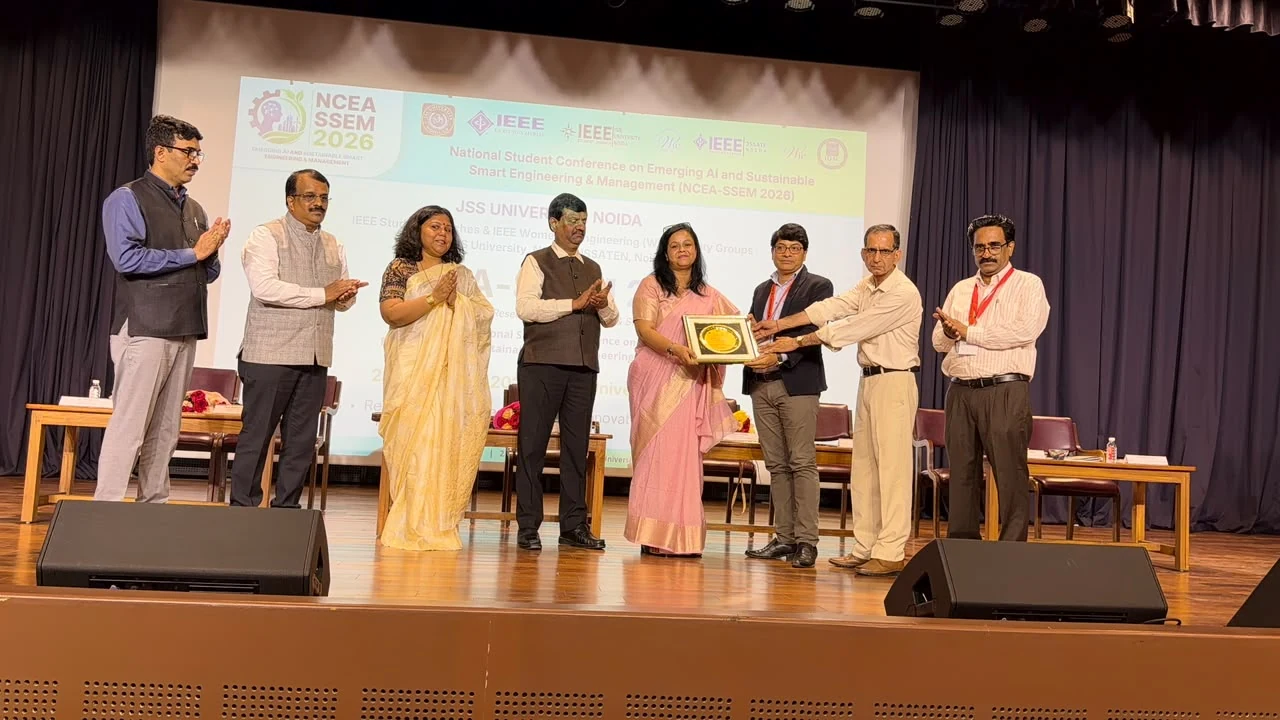 The Guest of Honour receiving a commemorative plaque on stage