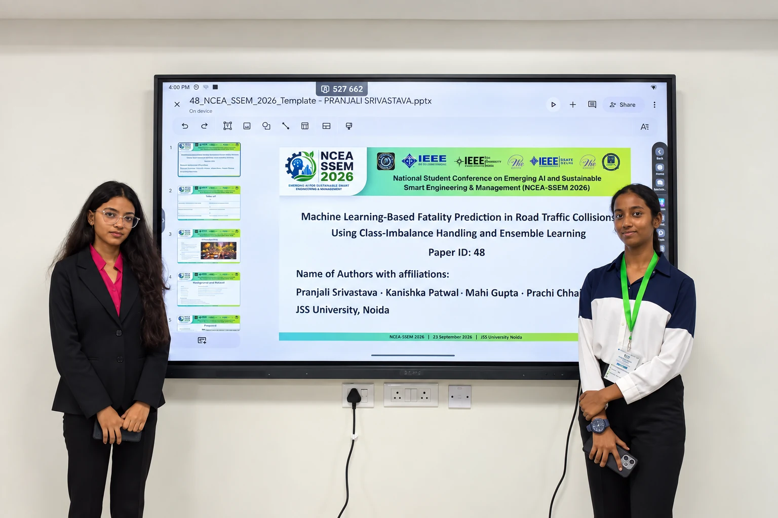 Student authors standing beside their conference presentation