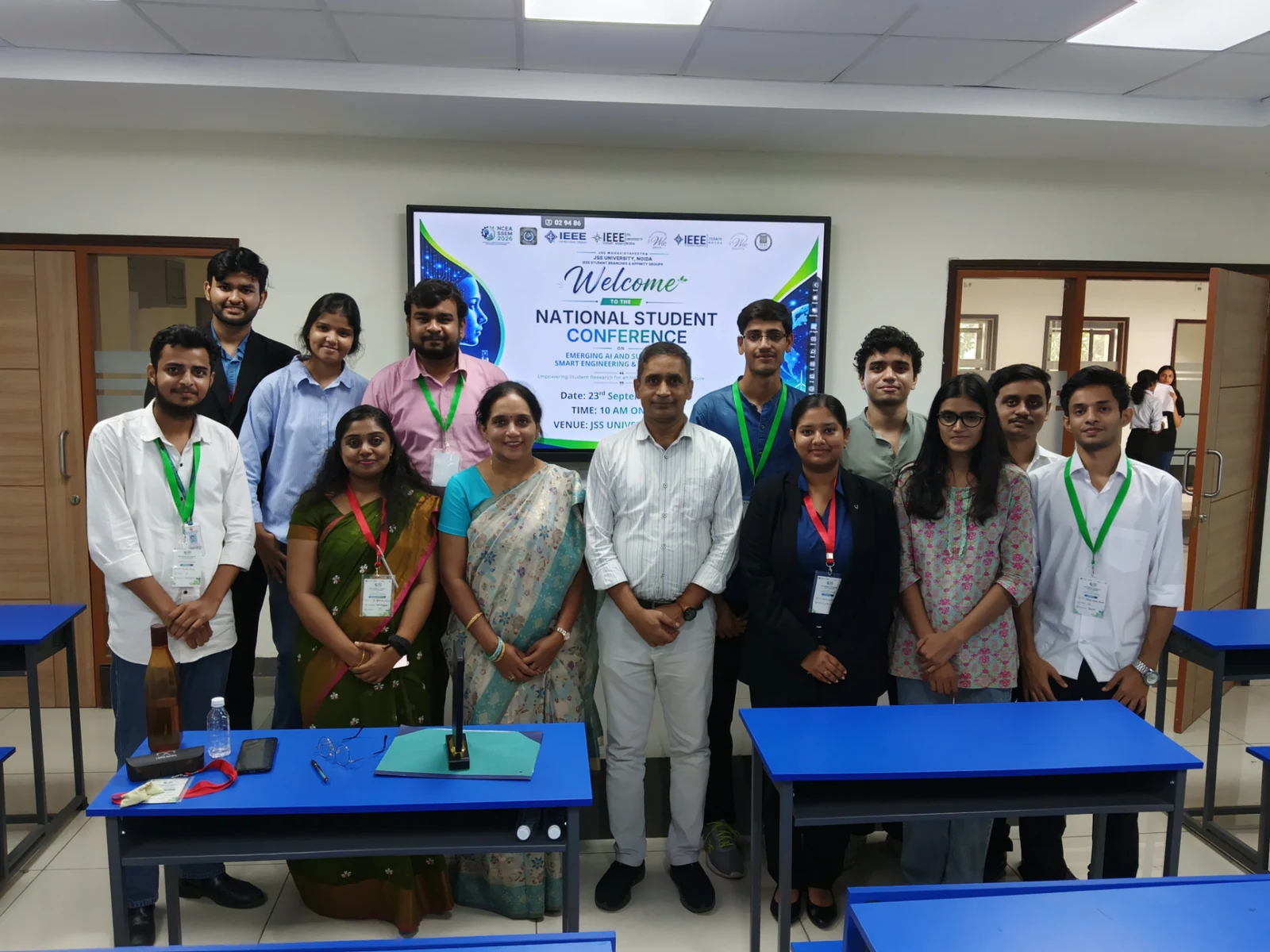 Session chairs, organizers, and student presenters gathered in a technical presentation room